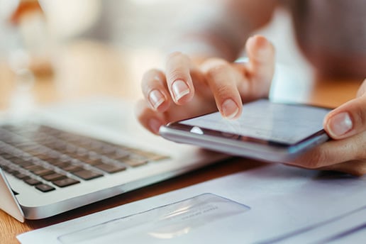 Close-up shot of someone's hands holding and scrolling through their smart phone