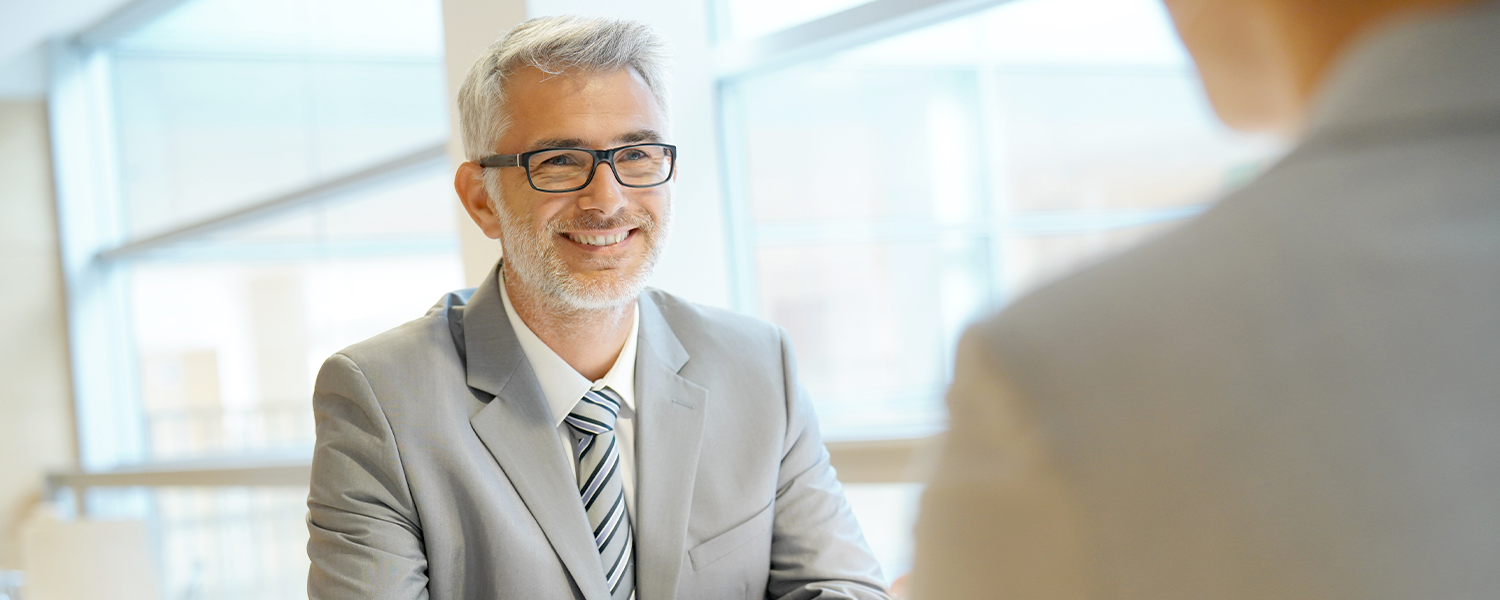 Man in suit speaking with tax advisor