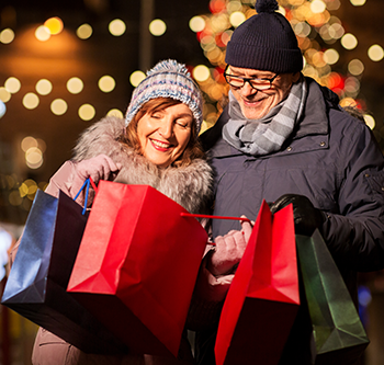 A couple looking into a holiday bag and smiling