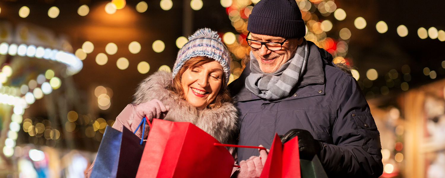 A couple looking into a holiday bag and smiling