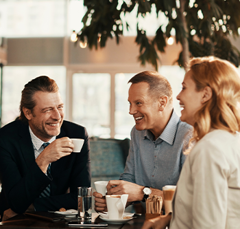 A group of coworkers sitting together drinking coffee