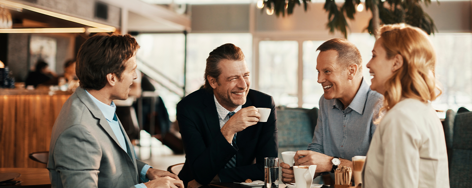 A group of coworkers sitting together drinking coffee