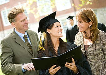 Parents standing next to graduating daughter holding her diploma